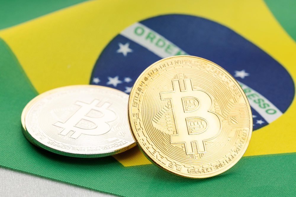 Moedas de Bitcoin sobre a bandeira do Brasil, simbolizando o avanço da criptoeconomia brasileira.